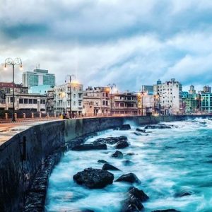 waves crash the boardwalk at el malecon havana