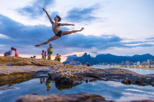 a gymnast leaps in rio de janeiro harbour