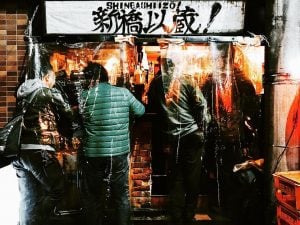 businessmen drink at an izakaya in shimbasi tokyo