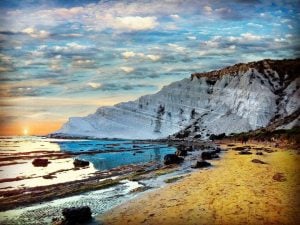 cliffs rising out of the sea in sicily