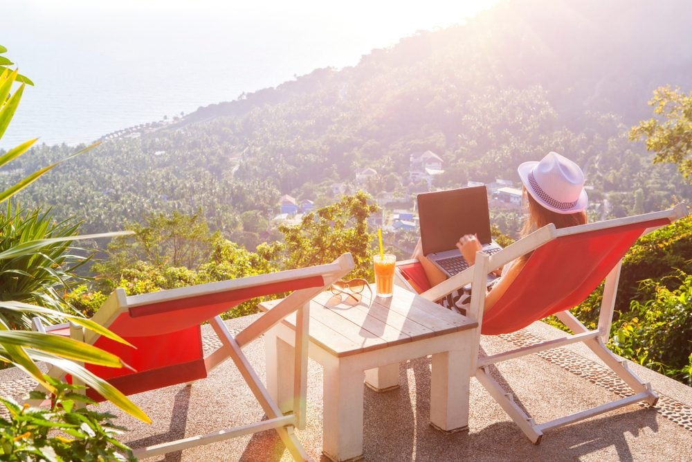 Freelancer having cocktails with a view