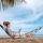 Woman relaxing and working on a hammock